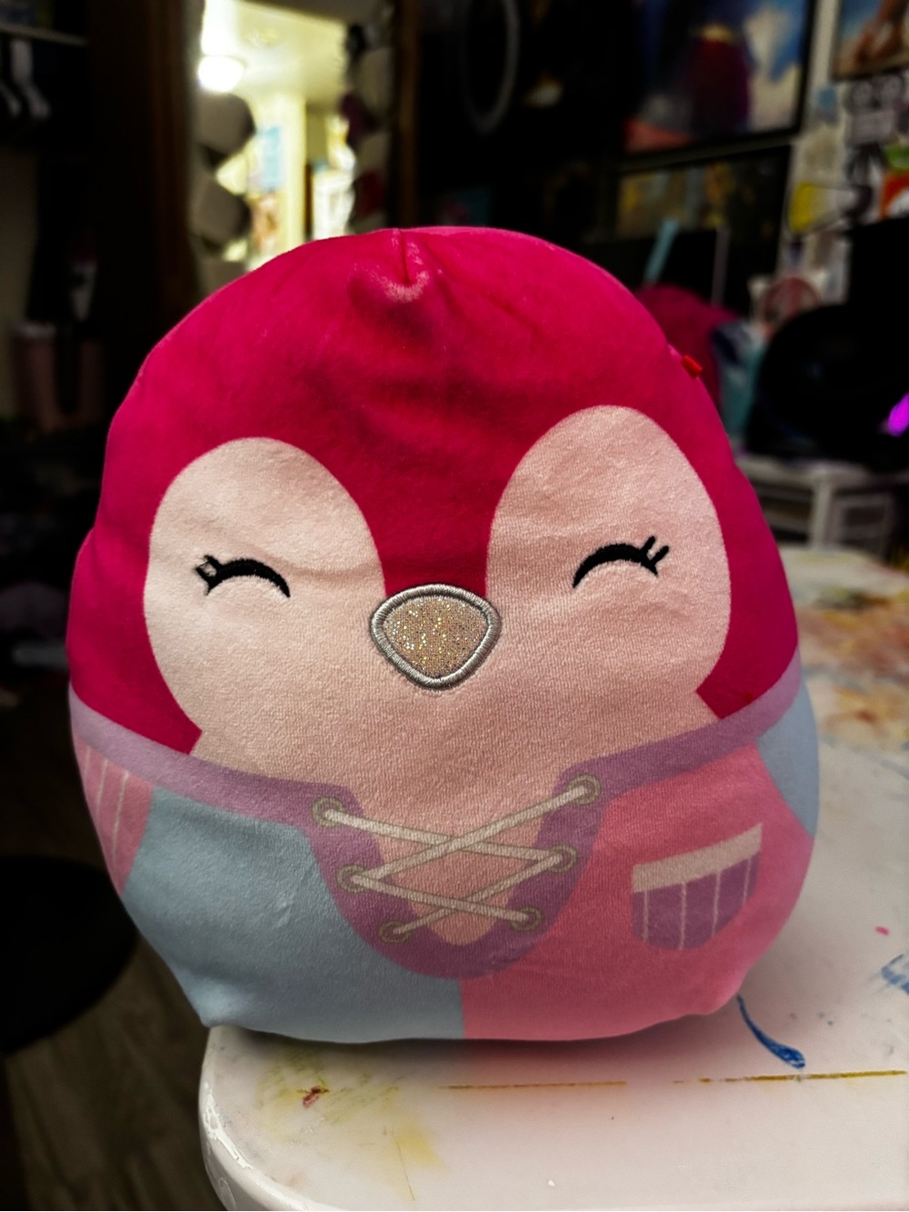 Pink Squishmallow Penguin wearing pink, purple and blue pajamas
